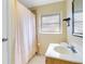 This bathroom features a shower with curtain, neutral walls, and a clean vanity with a bright light at 3000 Cashmere Dr, Orlando, FL 32827