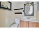 This bathroom includes updated vanity with wood finish, shelves, and decorative mirror with overhead lighting at 3000 Cashmere Dr, Orlando, FL 32827
