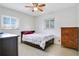 This cozy bedroom offers natural light and is complete with a ceiling fan and speckled flooring at 3000 Cashmere Dr, Orlando, FL 32827