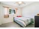 Bright bedroom with neutral walls, a striped bedspread and a ceiling fan at 3000 Cashmere Dr, Orlando, FL 32827