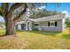A lovely one story home featuring an attached garage, arched entryway, and mature tree in the front yard at 3000 Cashmere Dr, Orlando, FL 32827