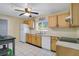 Bright kitchen features wooden cabinets, white appliances, tile floors and a ceiling fan at 3000 Cashmere Dr, Orlando, FL 32827