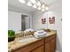 Elegant bathroom featuring a double sink vanity with granite counters, and decor at 4891 Clock Tower Dr, Kissimmee, FL 34746