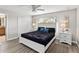 Inviting bedroom with a ceiling fan, matching nightstands, and closet at 4891 Clock Tower Dr, Kissimmee, FL 34746