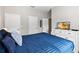 Spacious bedroom featuring a dresser with TV and multiple closets and doors at 4891 Clock Tower Dr, Kissimmee, FL 34746
