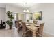 Comfortable dining room with decorative chandelier, seating for six, and sliding door access at 4891 Clock Tower Dr, Kissimmee, FL 34746