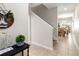 Elegant foyer with staircase and views of the dining area for a welcoming ambiance at 4891 Clock Tower Dr, Kissimmee, FL 34746