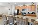 Gorgeous kitchen island with bar seating, stainless steel appliances, and wooden cabinetry at 4891 Clock Tower Dr, Kissimmee, FL 34746
