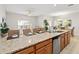 Open kitchen area with stainless steel appliances, granite counters and adjacent dining area at 4891 Clock Tower Dr, Kissimmee, FL 34746