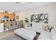 Open-concept living area with kitchen bar, stylish sofa, and sleek modern decor at 4891 Clock Tower Dr, Kissimmee, FL 34746