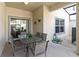 Covered patio with a glass table and chairs and a sliding glass door at 4891 Clock Tower Dr, Kissimmee, FL 34746