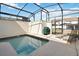A private screened-in pool area features a splash pool and lounge chairs for relaxing outdoors at 4891 Clock Tower Dr, Kissimmee, FL 34746
