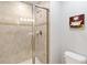 Tiled shower featuring glass door and decorative tile accent at 4891 Clock Tower Dr, Kissimmee, FL 34746
