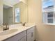 Bathroom featuring a double sink vanity, white countertop and cabinets, and bronze faucets at 195 Bull Frog Ln, Umatilla, FL 32784