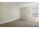 Bright bedroom with neutral walls, carpet flooring, and a window for natural light at 195 Bull Frog Ln, Umatilla, FL 32784