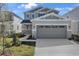 Charming home with a large two-car garage, stone accents, and a landscaped front yard at 195 Bull Frog Ln, Umatilla, FL 32784