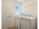 Laundry room featuring a washer, dryer, and window, providing a functional space at 195 Bull Frog Ln, Umatilla, FL 32784