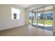 Bright living room with large sliding glass doors leading to a covered outdoor patio at 195 Bull Frog Ln, Umatilla, FL 32784