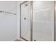 Modern bathroom with a tiled walk-in shower, glass door, and bronze shower head at 195 Bull Frog Ln, Umatilla, FL 32784