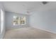Spacious bedroom features neutral carpet, ceiling fan, and bright natural light from the double windows at 2078 Cypress Bay Blvd, Kissimmee, FL 34743