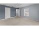 Bedroom view showcasing carpeting, large window, ceiling fan, closet, and entry to the bathroom at 2078 Cypress Bay Blvd, Kissimmee, FL 34743