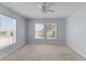 This bedroom has a ceiling fan and two large windows that let in plenty of natural light at 2078 Cypress Bay Blvd, Kissimmee, FL 34743
