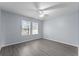 A spacious bedroom showcasing modern gray floors, providing comfort and elegance at 2078 Cypress Bay Blvd, Kissimmee, FL 34743