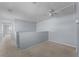 Hallway with neutral carpet, light blue walls, and white ceiling fans at 2078 Cypress Bay Blvd, Kissimmee, FL 34743