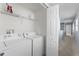 Functional laundry room featuring modern washer and dryer appliances, ensuring easy laundry days at 2078 Cypress Bay Blvd, Kissimmee, FL 34743