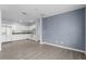 Open floor plan with a view of kitchen, wood look floors, and light blue accent wall at 2078 Cypress Bay Blvd, Kissimmee, FL 34743
