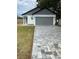 Newly constructed home with gray siding, two-car garage, and a paved driveway at 726 Eldridge St, Orlando, FL 32803