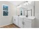 Bathroom with double vanity sinks, granite countertops and a walk-in shower at 1496 August Gray Dr, Kissimmee, FL 34744