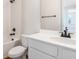 Clean bathroom featuring white fixtures, a shower-tub combo, and modern black hardware at 1496 August Gray Dr, Kissimmee, FL 34744