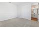 Cozy bedroom with plush carpet and a view to an ensuite bathroom through an open doorway at 1496 August Gray Dr, Kissimmee, FL 34744