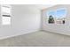 Bright bedroom featuring neutral paint, carpet, and a large window offering natural light at 1496 August Gray Dr, Kissimmee, FL 34744