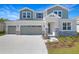 Charming two-story home featuring a three-car garage and stone accents at 1496 August Gray Dr, Kissimmee, FL 34744