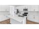 Bright kitchen with white cabinets, stainless steel appliances and center island at 1496 August Gray Dr, Kissimmee, FL 34744