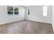 Living room featuring wood-look flooring, natural light and neutral paint at 1496 August Gray Dr, Kissimmee, FL 34744