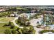 Overview of a community with multiple pools and recreation areas surrounded by palm trees and manicured lawns at 1676 Moon Valley Dr, Davenport, FL 33896
