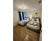 Cozy bedroom featuring two twin beds with gray and pink accents, complemented by modern decor and natural light at 1676 Moon Valley Dr, Davenport, FL 33896