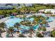 A lazy river with a tropical theme featuring slides, waterfalls, and lush landscaping at 1676 Moon Valley Dr, Davenport, FL 33896