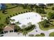 Aerial view of a sand volleyball court in a lush community setting with palm trees and green lawns at 1676 Moon Valley Dr, Davenport, FL 33896