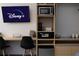 Close-up of a desk featuring a TV, microwave, coffeemaker, and safe at 5245 W Irlo Bronson Memorial Hwy # 160, Kissimmee, FL 34746
