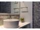 Close-up of a bathroom sink featuring a brick accent wall and stylish decorative elements at 5245 W Irlo Bronson Memorial Hwy # 160, Kissimmee, FL 34746