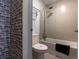 Clean bathroom featuring a toilet and a shower tub with brick-like tile on one wall at 5245 W Irlo Bronson Memorial Hwy # 160, Kissimmee, FL 34746