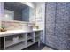 Modern bathroom with brick accent wall, sleek sink, and open shelving storage at 5245 W Irlo Bronson Memorial Hwy # 160, Kissimmee, FL 34746