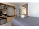 Cozy bedroom featuring a kitchenette, and a modern bathroom beyond an arched doorway at 5245 W Irlo Bronson Memorial Hwy # 160, Kissimmee, FL 34746