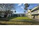 Exterior view of the property featuring a central lawn, palm trees, and walkways at 5245 W Irlo Bronson Memorial Hwy # 160, Kissimmee, FL 34746