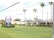 A charming building with lush green grass, manicured hedges, and multiple tall palm trees, offers a welcoming and serene environment at 5245 W Irlo Bronson Memorial Hwy # 160, Kissimmee, FL 34746