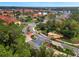 Scenic aerial view of the gated community with lush landscaping, a lake, and community amenities at 121 Madiera Beach Blvd, Kissimmee, FL 34746